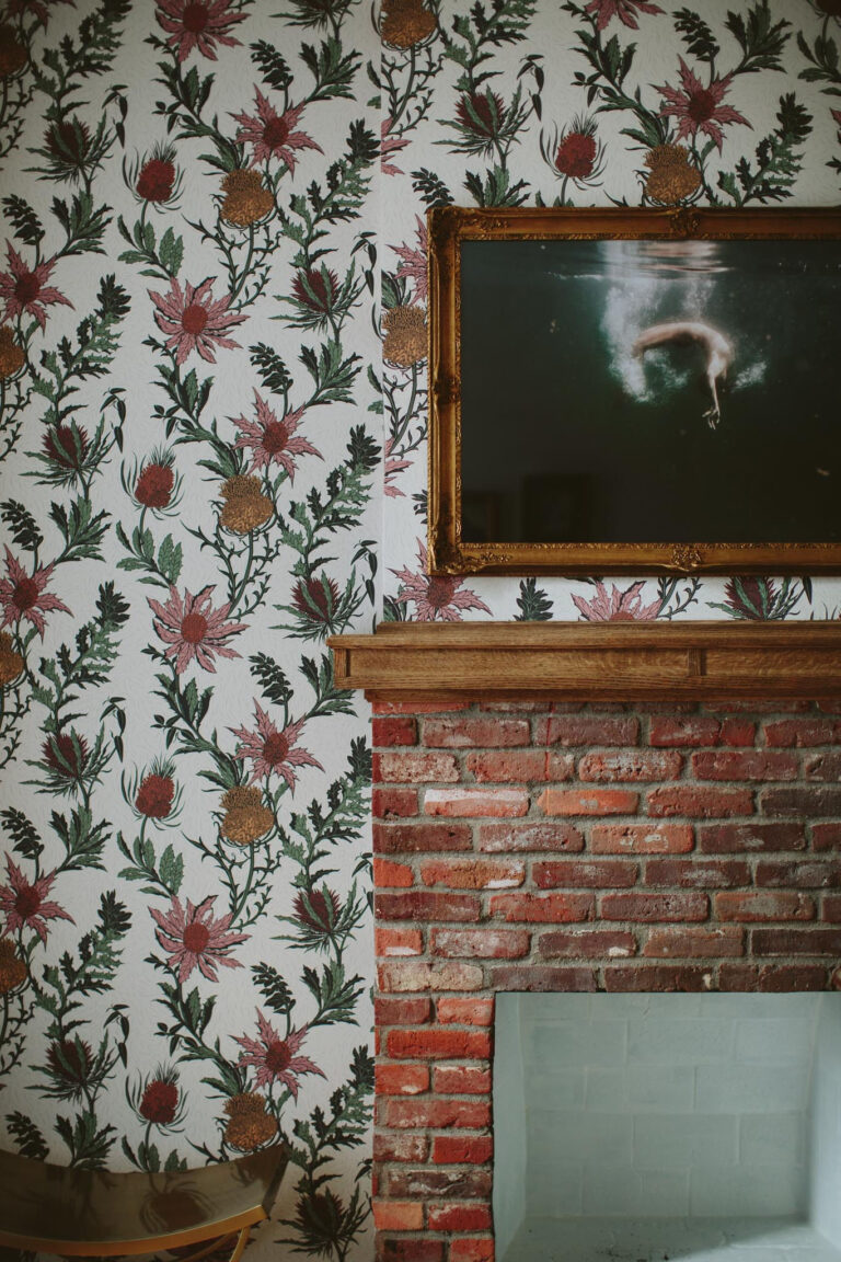Floral wallpaper over a fireplace